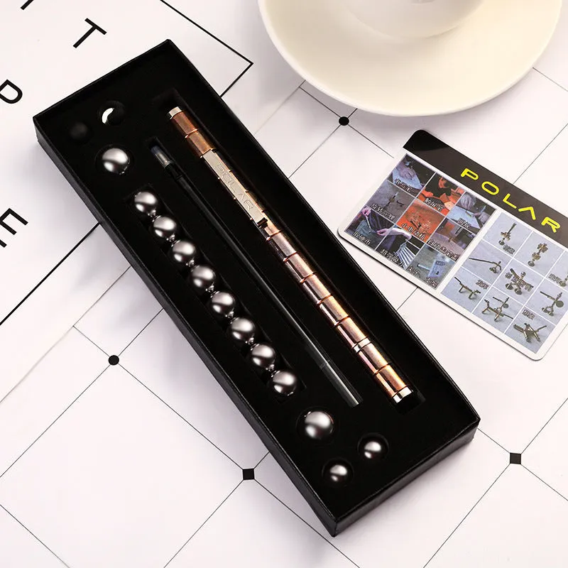 Magnetic modular fidget pen with silver finish, magnetic rings, steel balls, and capacitive head on a table