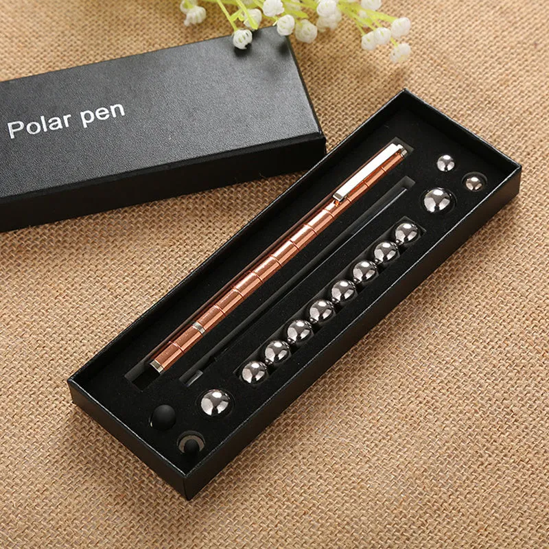 Magnetic modular fidget pen with silver finish, magnetic rings, steel balls, and capacitive head on a table