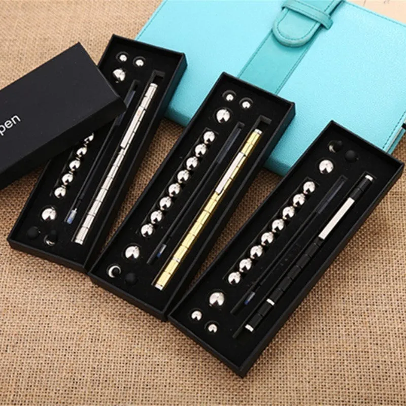 Magnetic modular fidget pen with silver finish, magnetic rings, steel balls, and capacitive head on a table