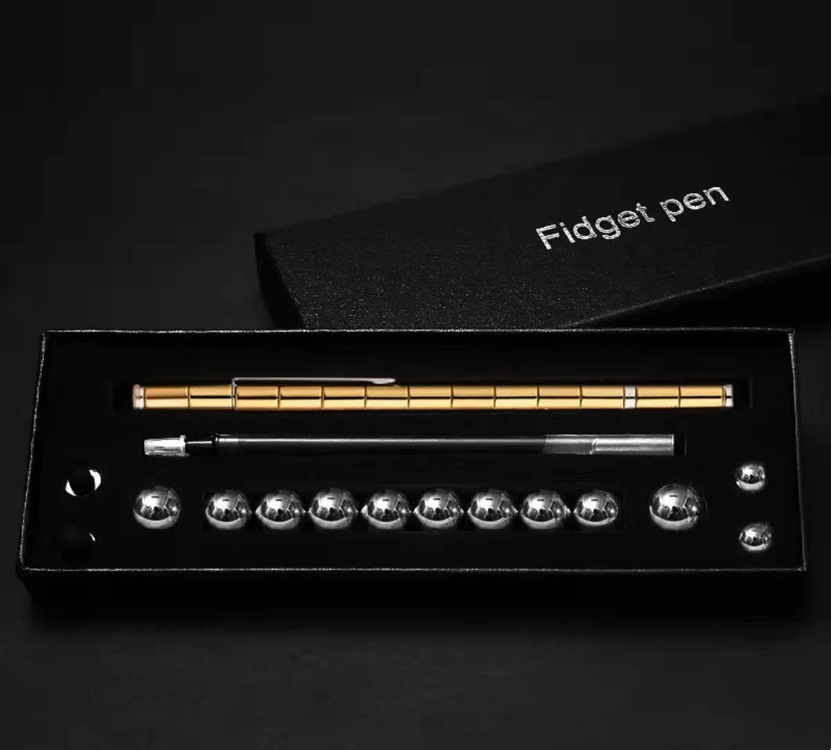 Magnetic modular fidget pen with silver finish, magnetic rings, steel balls, and capacitive head on a table