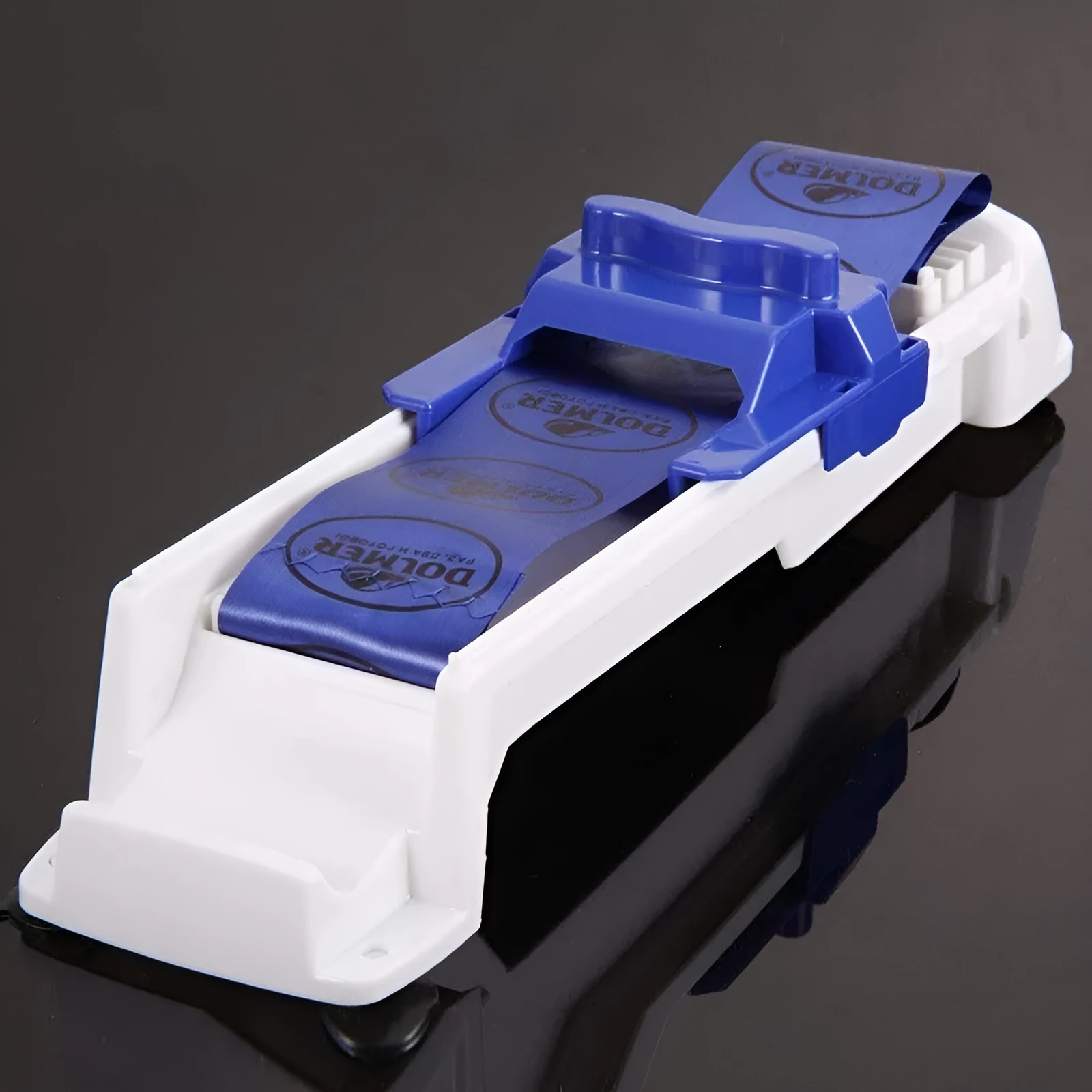 Blue plastic vegetable meat roller from Home Sushi Machine, 36cm by 10cm by 8cm, on a kitchen counter with English packaging