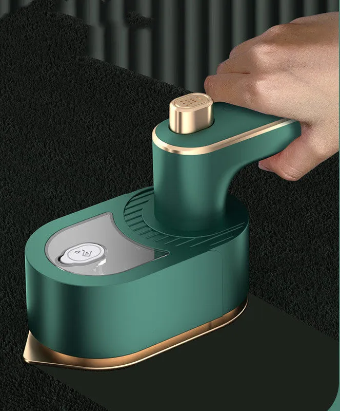 Folding handheld garment steamer in beige with compact design for travel