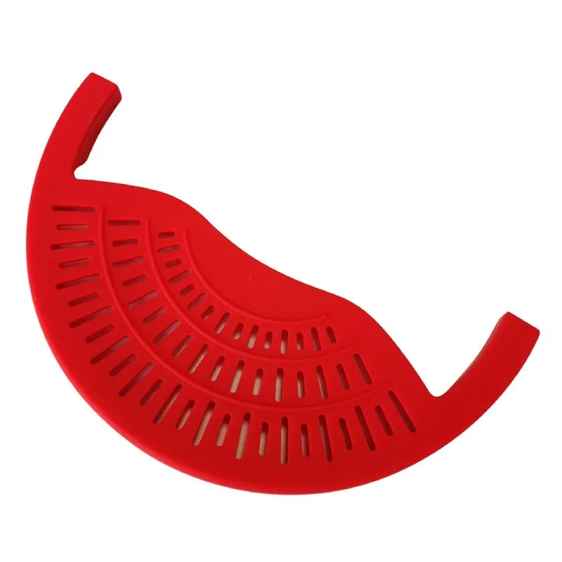Black silicone food oil drainer snapped onto a pot rim, with liquid being poured off