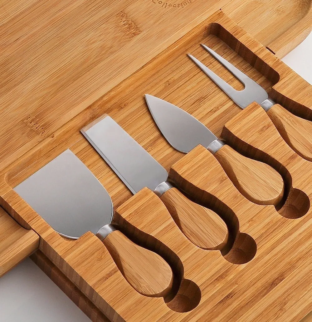 Square bamboo cutting board with drawer holding four-piece knife and fork set in wood colour