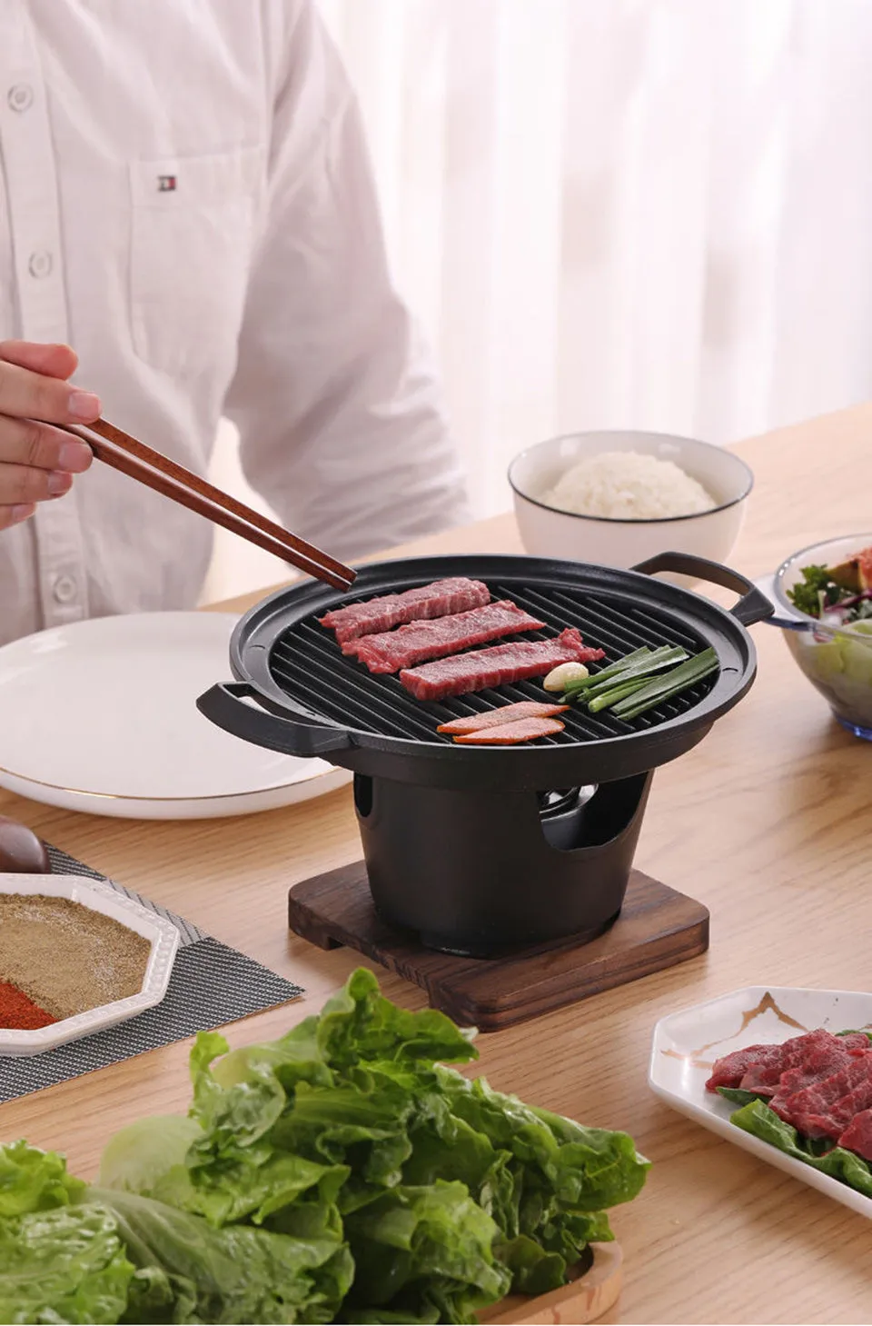Mini BBQ grill alcohol stove with double-head flame and non-stick plate on tabletop