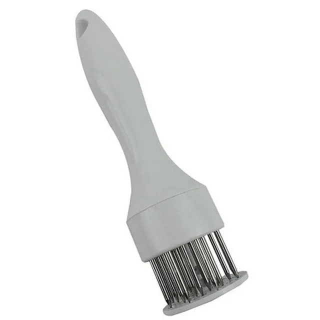 Pine meat needle tenderiser tool for steak with white handle and metal needles, shown on a kitchen surface