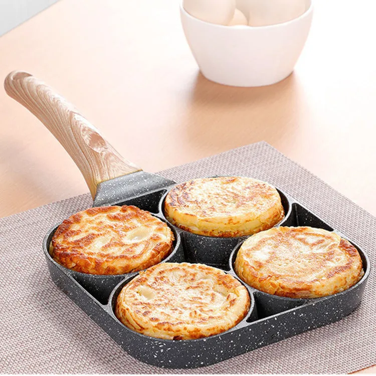 Non-stick egg dumpling frying pan in black aluminium with two holes for cooking breakfast burgers