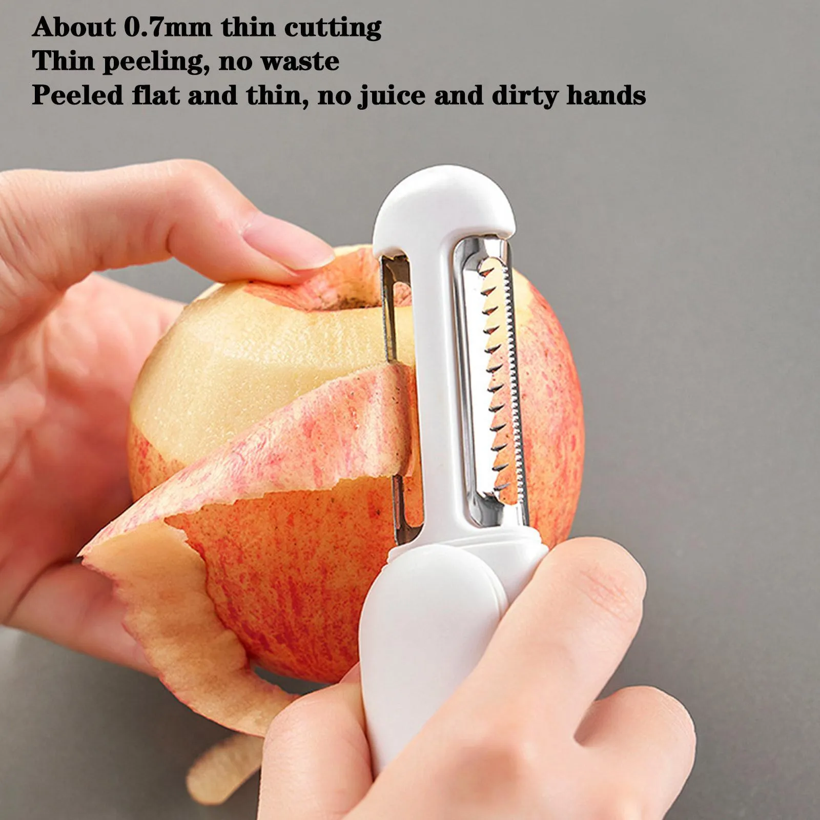 White 3 in 1 rotary paring knife with 360 degree rotating stainless steel blade on a kitchen counter