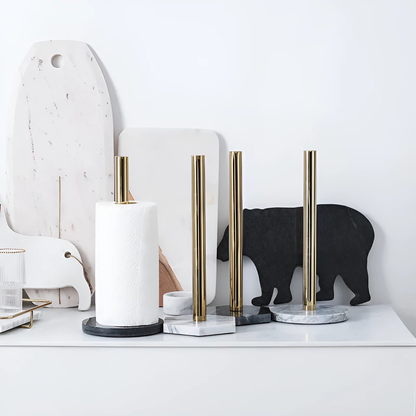 Marble kitchen roll holder with stainless steel gilded finish on kitchen countertop