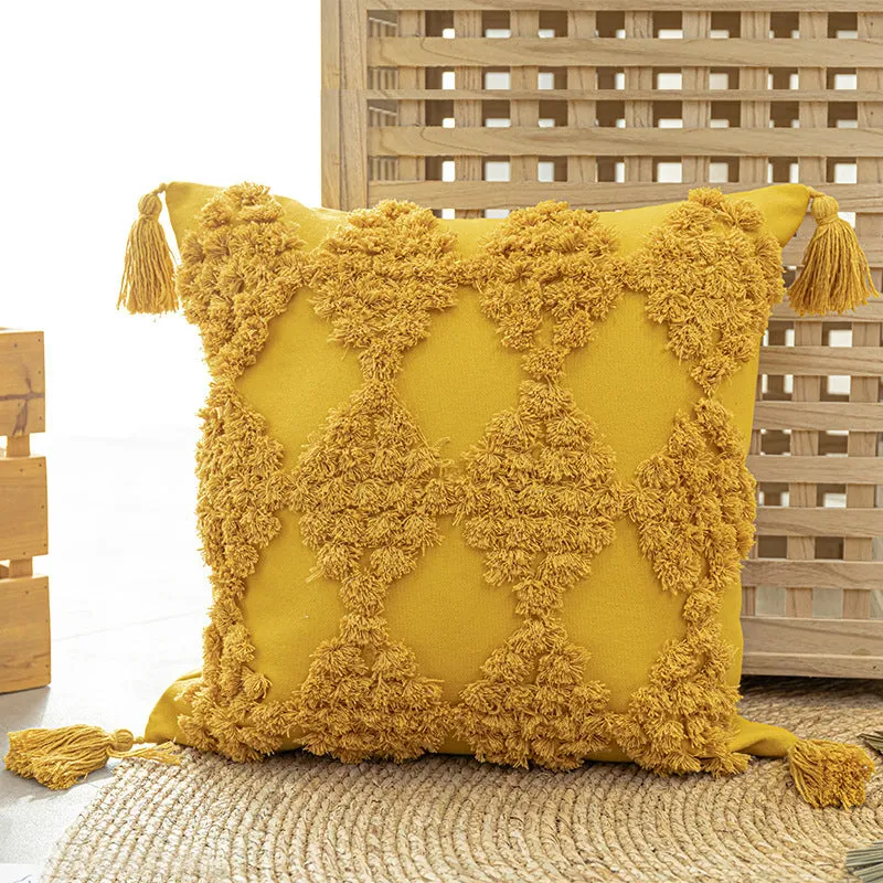 Nordic tufted throw pillow in beige cotton canvas with tassels on a sofa