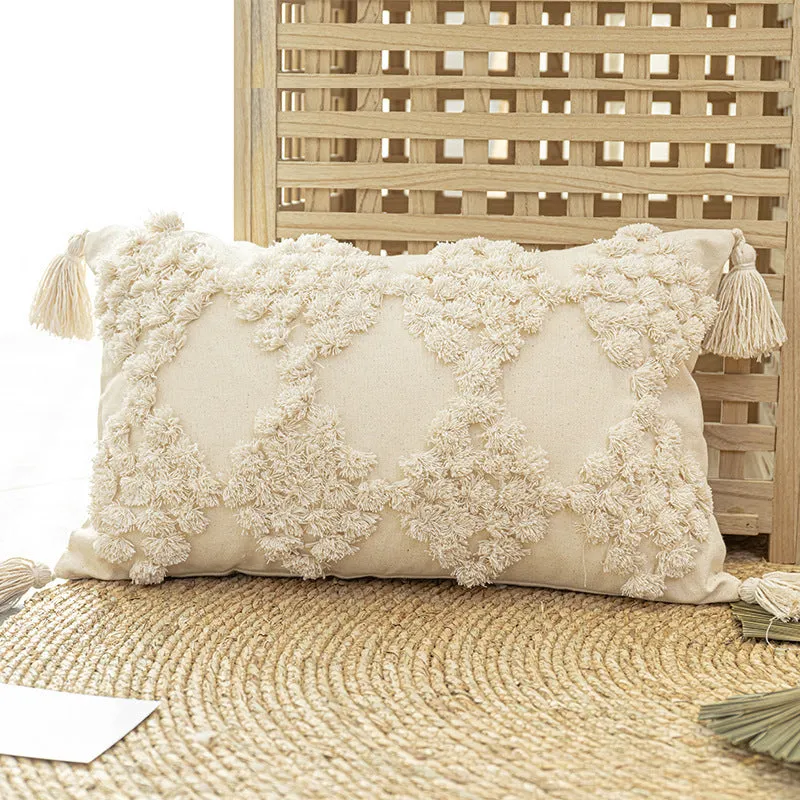 Nordic tufted throw pillow in beige cotton canvas with tassels on a sofa