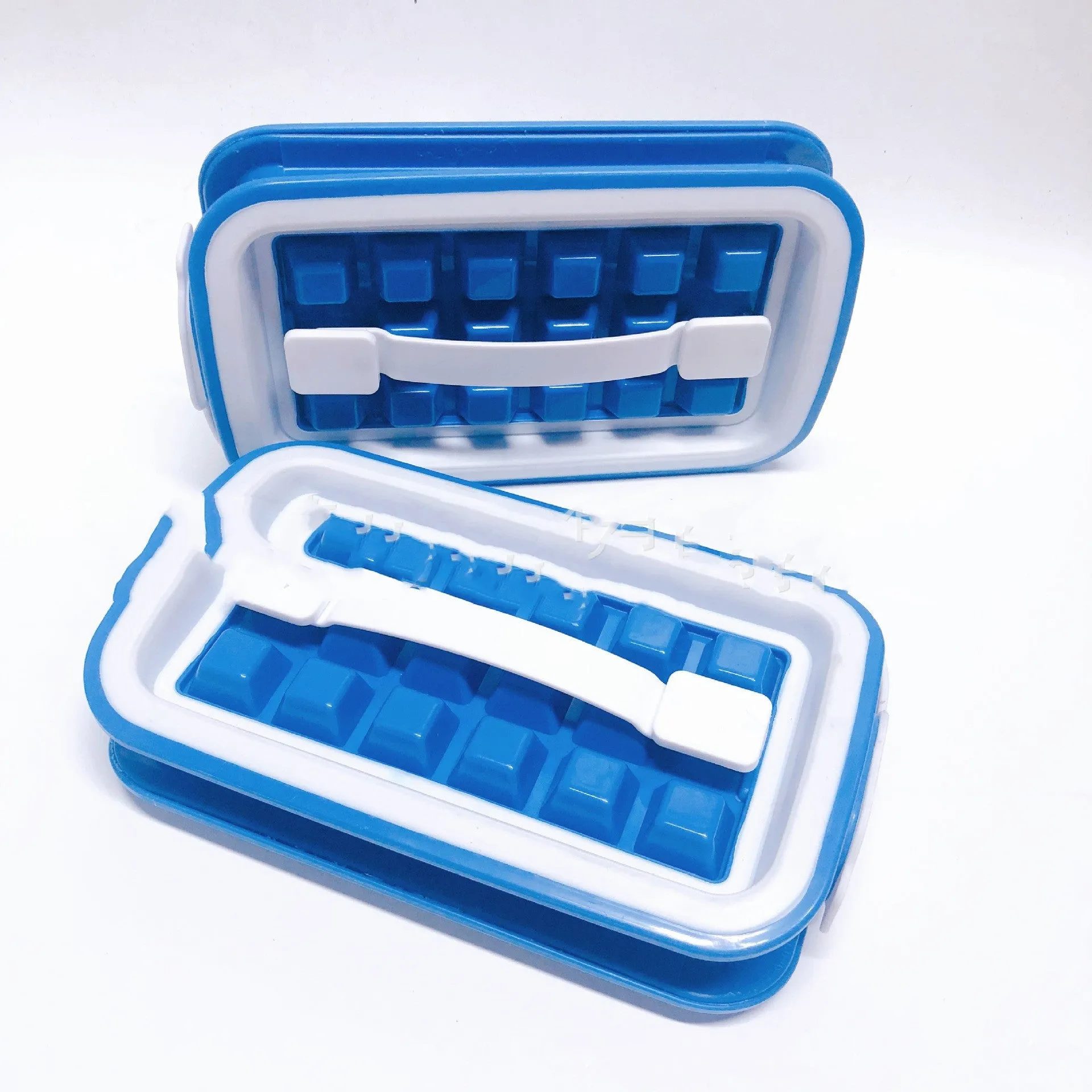Blue silicone ice cube tray with 36 square cavities and a lid on a wooden table