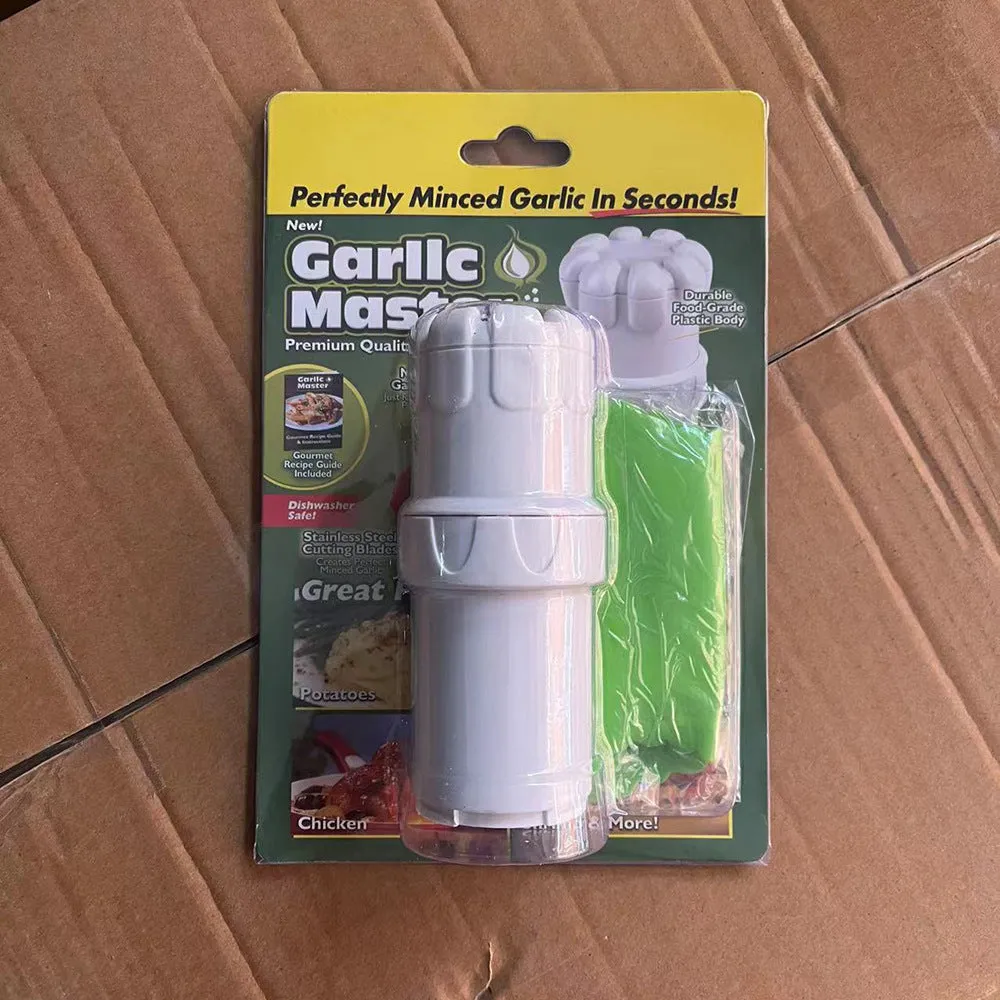 White ABS plastic garlic press with peeler on kitchen countertop