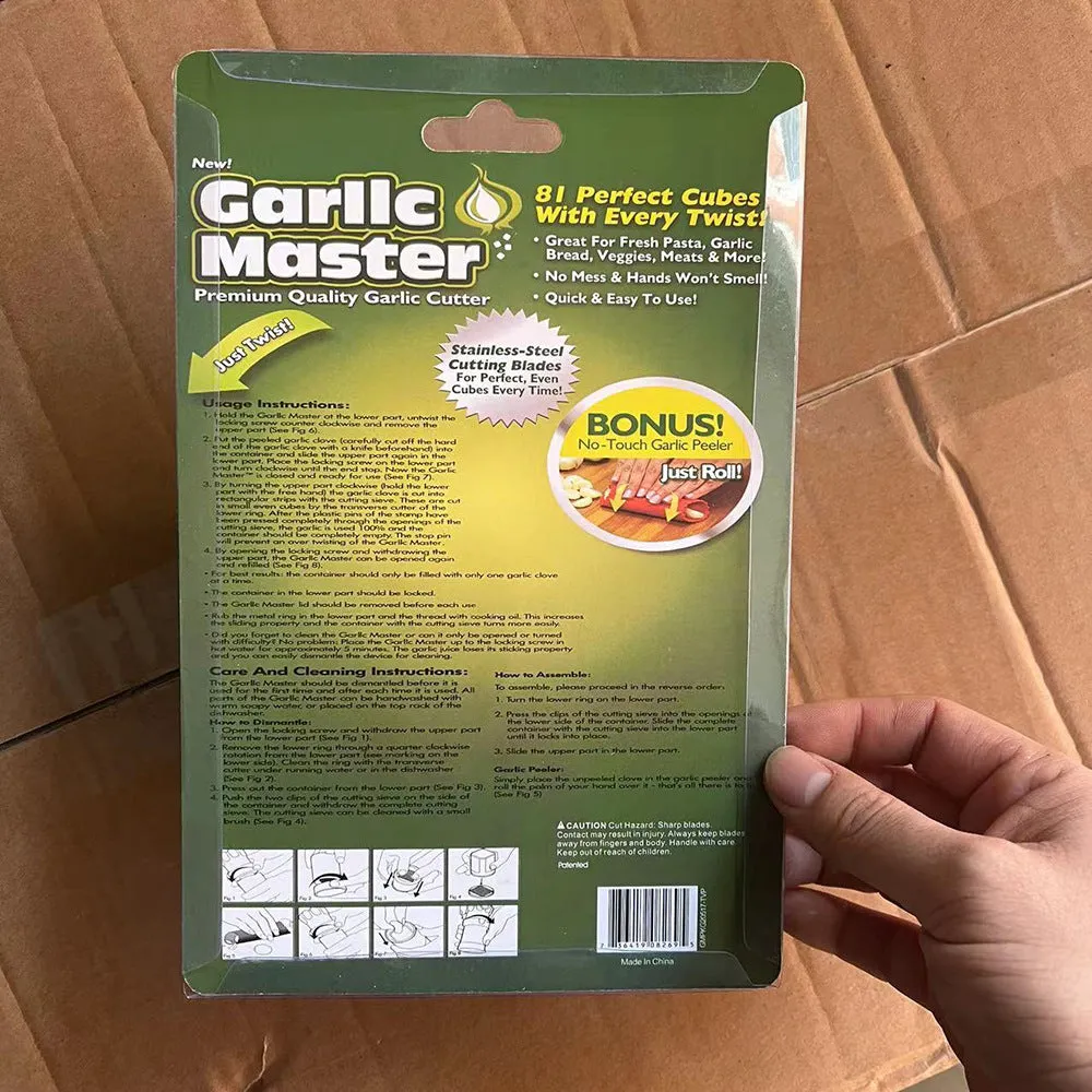 White ABS plastic garlic press with peeler on kitchen countertop