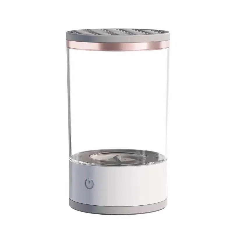 Grey and white electric makeup brush cleaner with USB charging cable on a wooden surface
