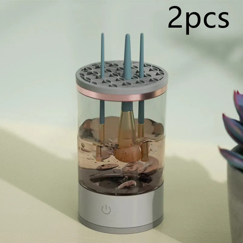 Grey and white electric makeup brush cleaner with USB charging cable on a wooden surface
