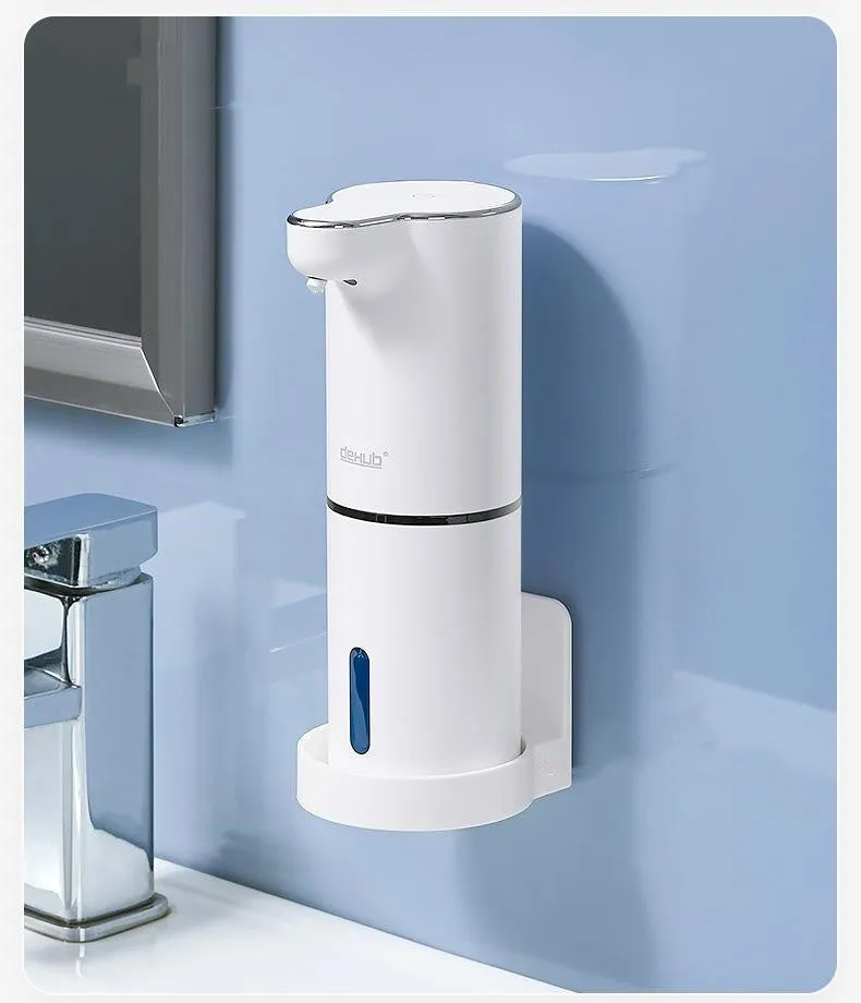 White ABS automatic sensor soap dispenser on countertop with USB cable, dispensing foam hand sanitiser.