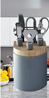 Stainless steel kitchen gadget set with whisk, grater, peeler, fruit knife, scissors, and tray lifter in grey