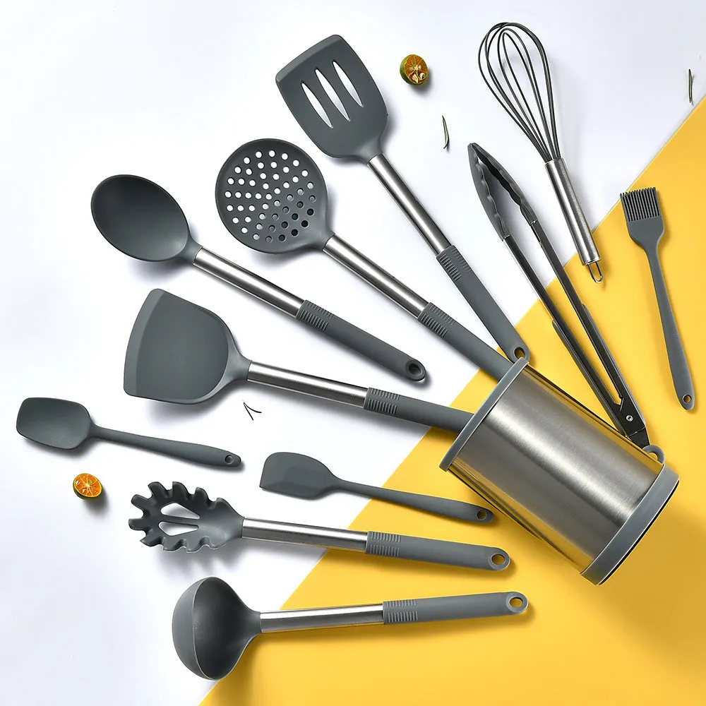 12-piece silicone kitchen utensil set in rotating storage bucket, including spatula, spoon, ladel, and egg beater on kitchen counter.