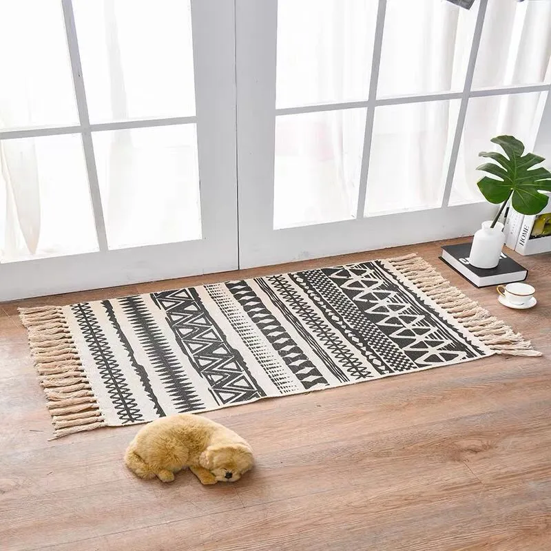 Handwoven cotton linen floor mat 60x90cm in ethnic style with natural plant dye, placed on a wooden floor