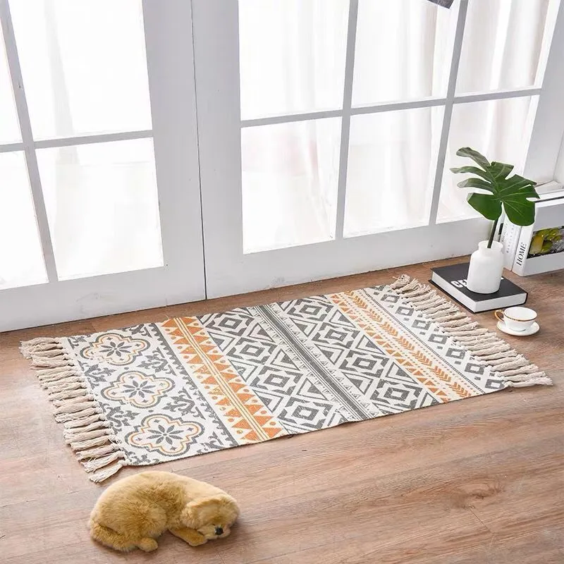 Handwoven cotton linen floor mat 60x90cm in ethnic style with natural plant dye, placed on a wooden floor
