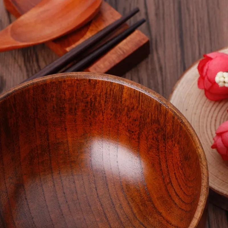 Set of four round wooden bowls in natural wood colour from 10x6.5cm to 11.8x6.7cm