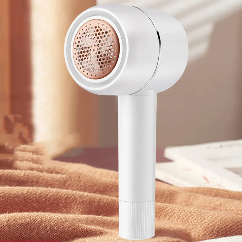 White rechargeable lint remover with hidden hair collection container and detachable three-blade head on white background