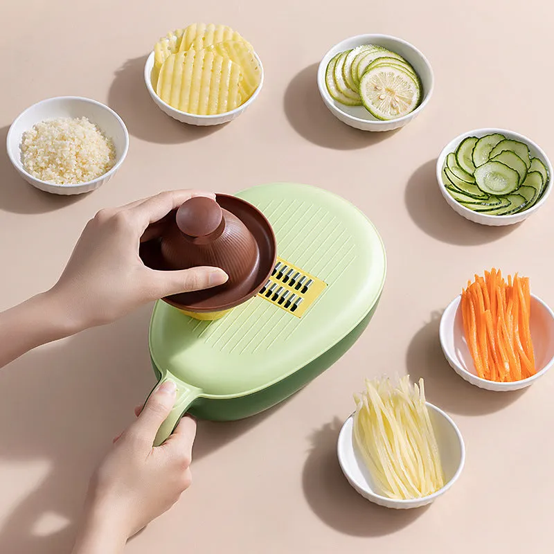 Avocado green vegetable grater with stainless steel blades on kitchen counter