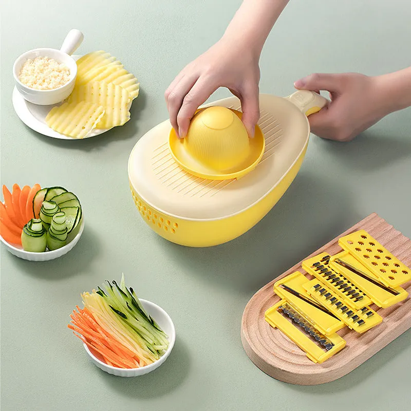 Avocado green vegetable grater with stainless steel blades on kitchen counter