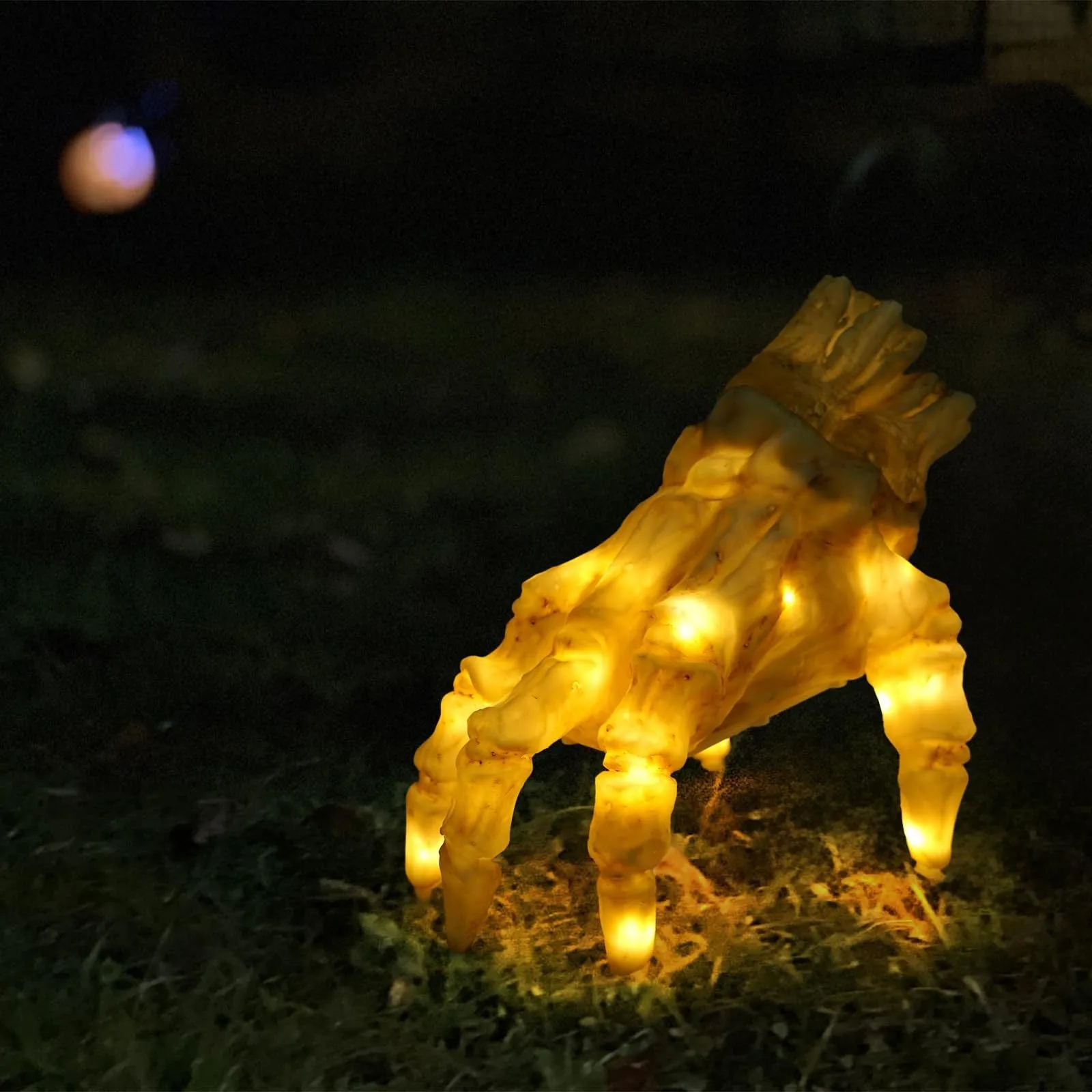 Halloween electric luminous crawling hand made of realistic vinyl with glowing lights on a floor
