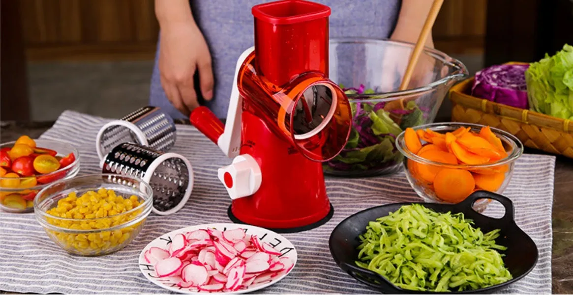 Spiralizer 3-blade vegetable slicer with transparent barrel and red plastic body on white background
