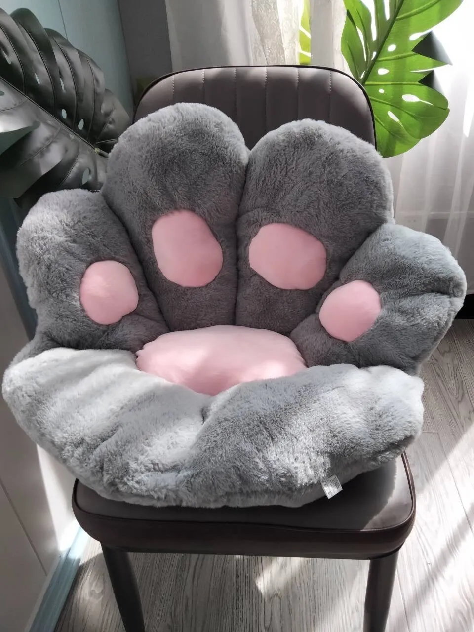 Plush semi surrounded cushion in paw shape on an office chair, available in multiple colours