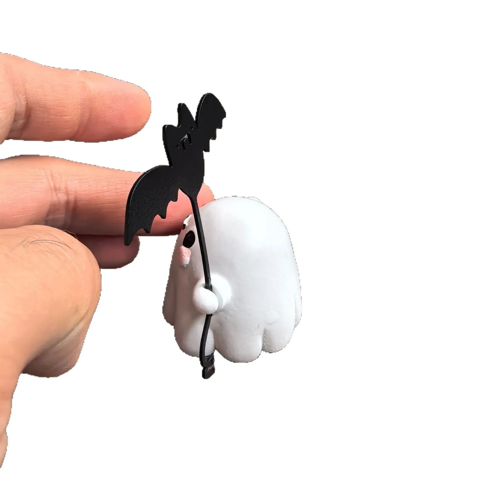 Miniature ghost walking dog statue holding a bat, a small resin Halloween ornament.