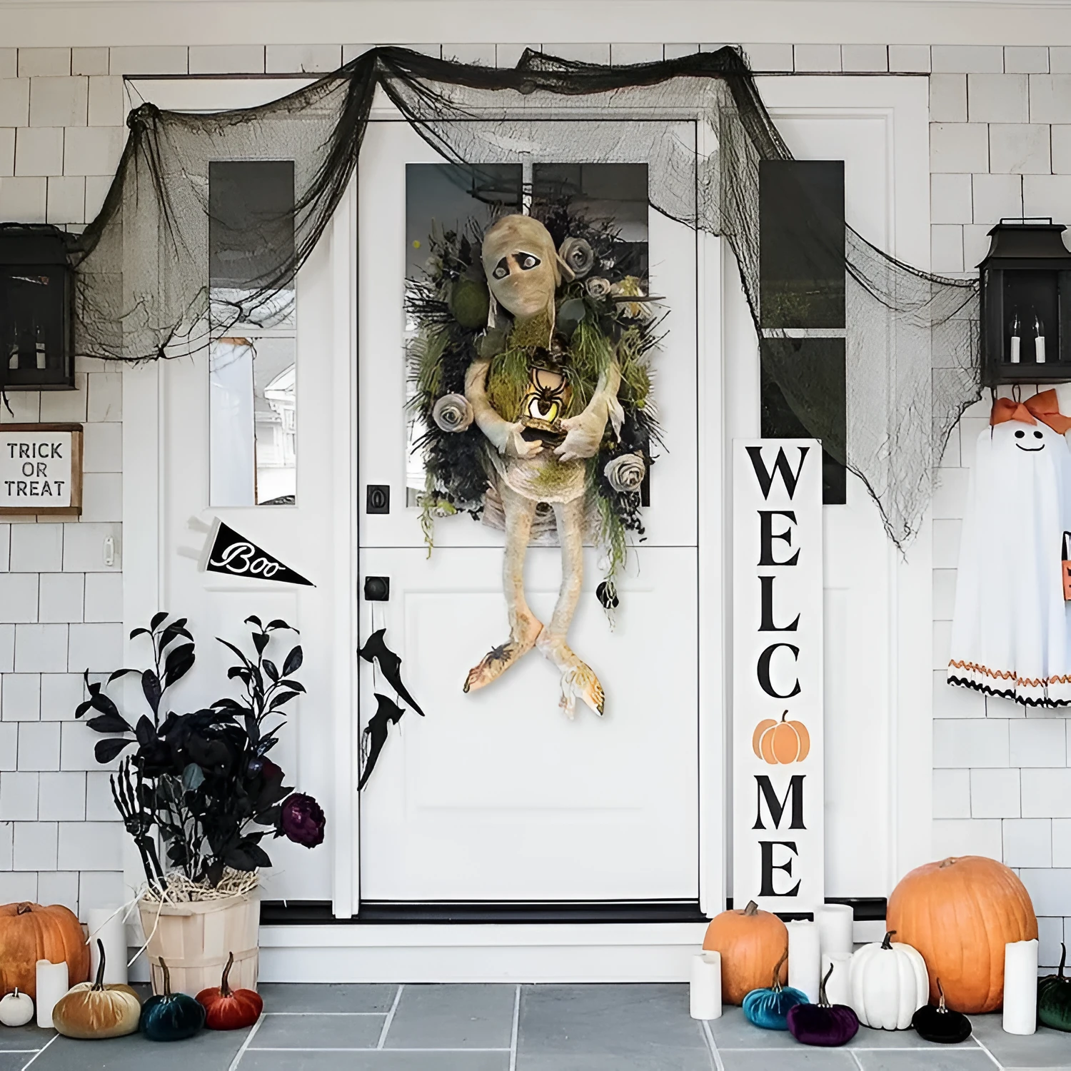 Three-dimensional mummy Halloween wreath with skeleton hands on a wooden door