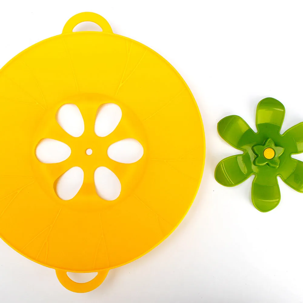 Silicone spill-proof pot cover in black, size 30x26cm, resting on a pot