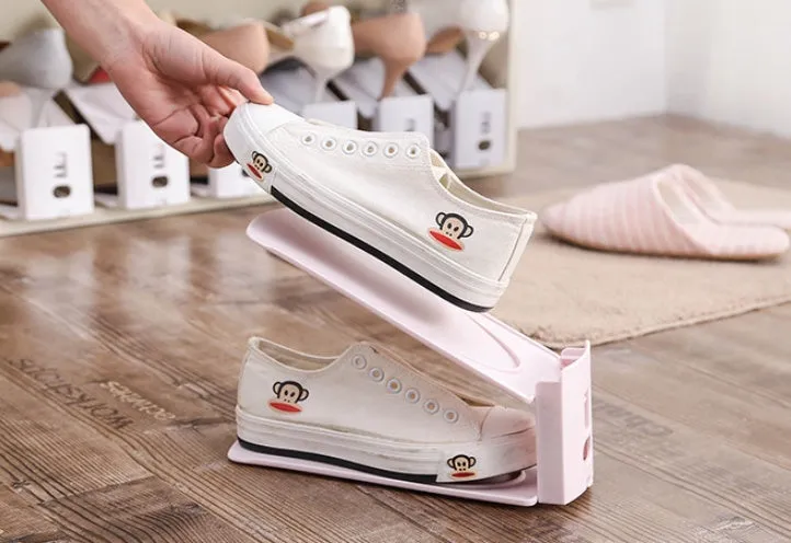 Double-layer adjustable shoe storage rack in white, holding two pairs of shoes