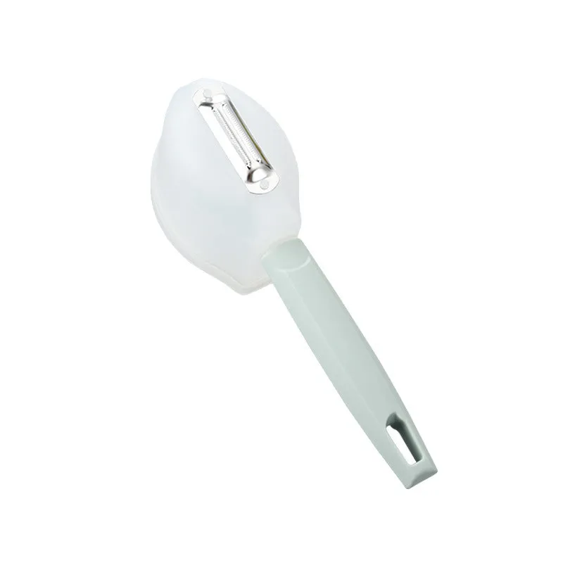 Stainless steel fruit peeler with pink PP plastic handle on a light background