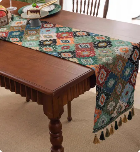 European retro style long table flag with handwoven tassels draped over a wooden sideboard