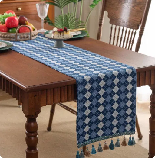 European retro style long table flag with handwoven tassels draped over a wooden sideboard