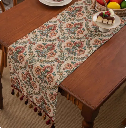 European retro style long table flag with handwoven tassels draped over a wooden sideboard
