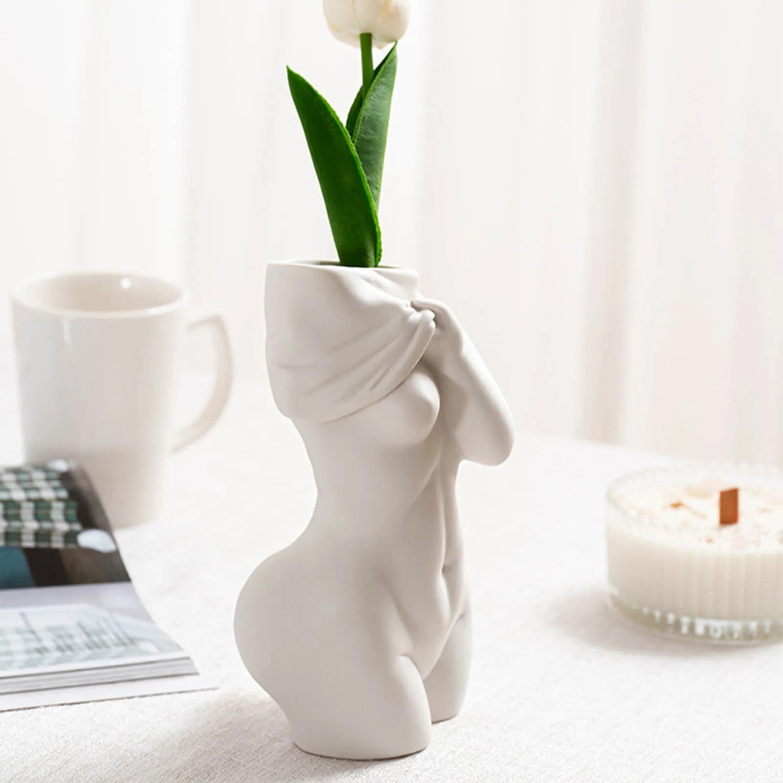 White porcelain figurative human vase with 21.2cm height on a shelf