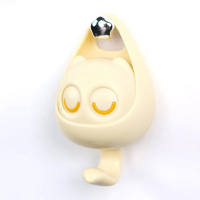 Cream white cat-shaped adhesive wall hook with winking eyes, 2.5kg capacity, 105x61x45mm