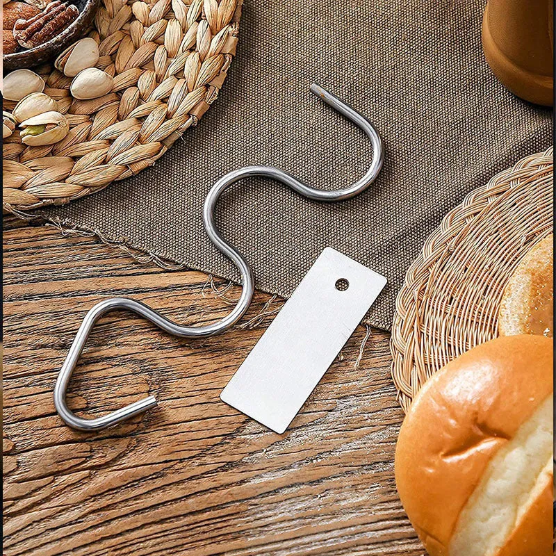 Stainless steel peanut butter mixer stirring rod on a kitchen counter with a jar of peanut butter