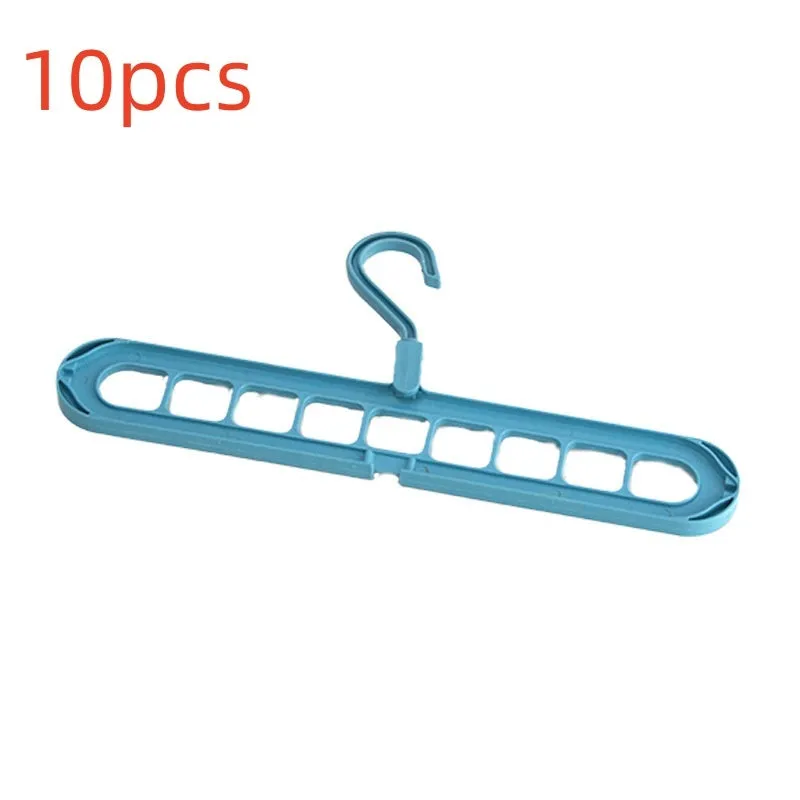 A green plastic folding hanger with nine holes for holding trousers or skirts.