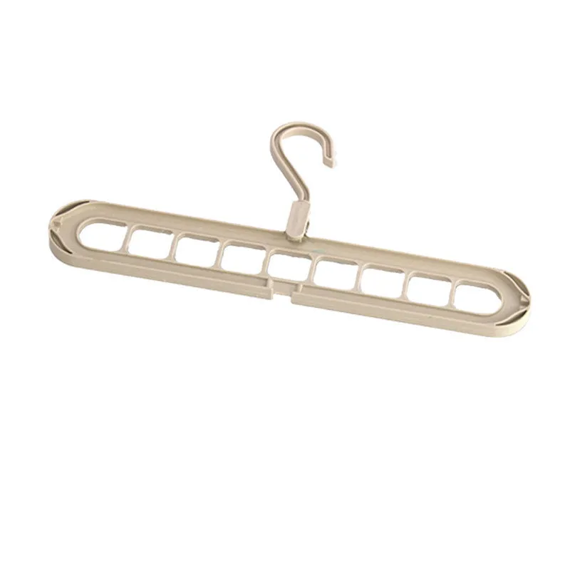 A green plastic folding hanger with nine holes for holding trousers or skirts.