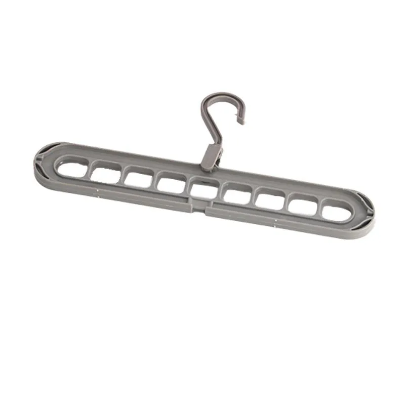 A green plastic folding hanger with nine holes for holding trousers or skirts.
