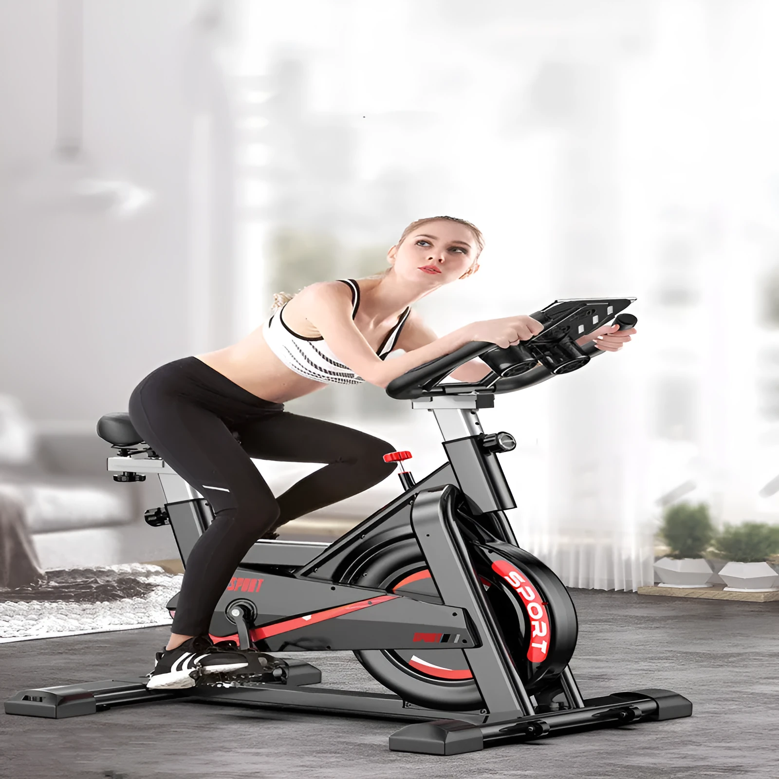 Black upright spinning bike with padded saddle and handlebars for home fitness