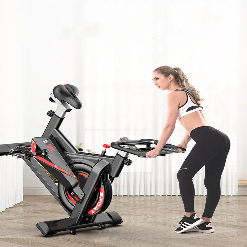 Black upright spinning bike with padded saddle and handlebars for home fitness