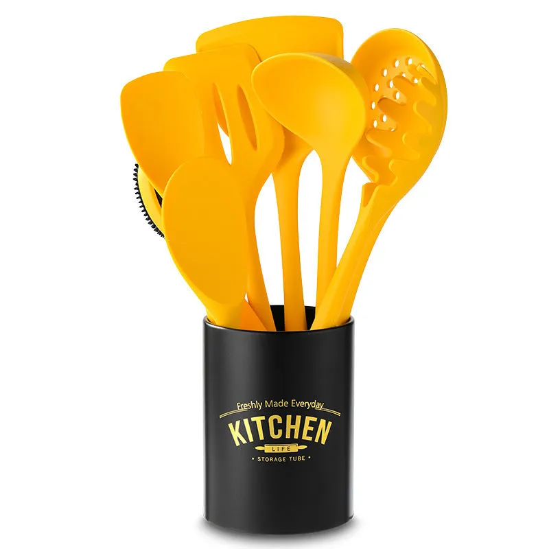 Yellow nonstick silicone and nylon cooking spoon and spatula set on a light background