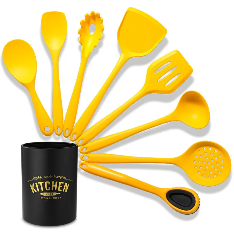 Yellow nonstick silicone and nylon cooking spoon and spatula set on a light background